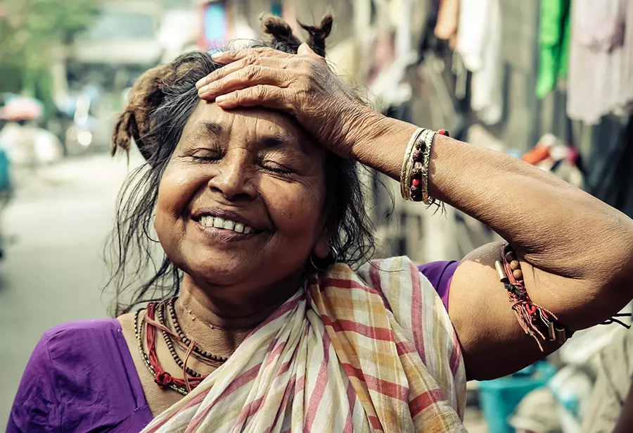 A woman smiles while standing in the sun