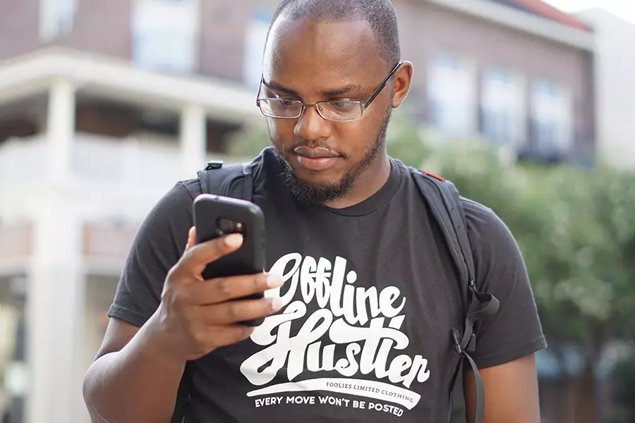 A young man looks at cellphone